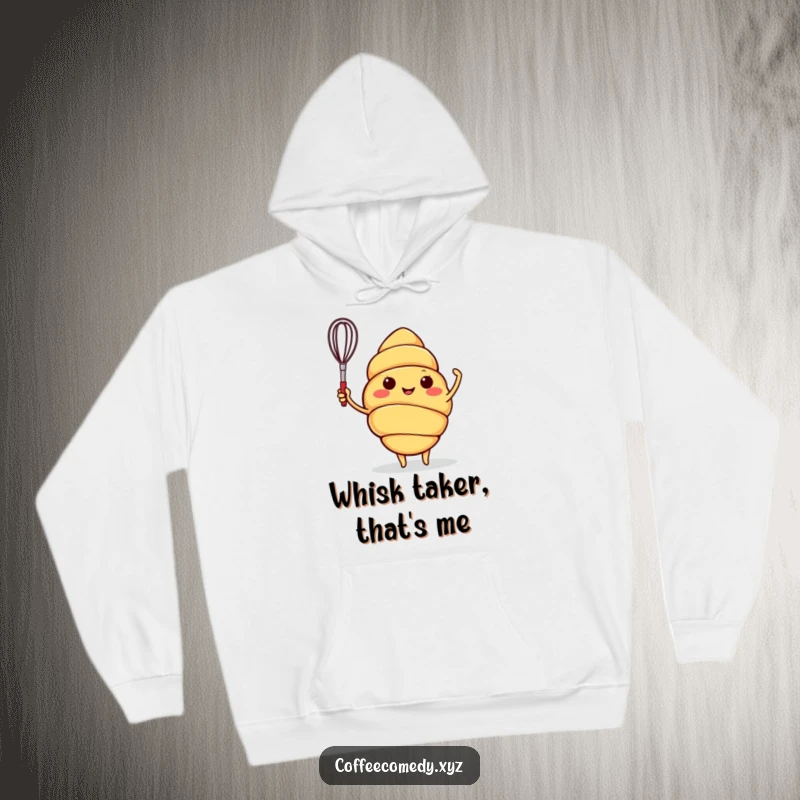 Funny hoodie showcasing a smiling croissant character energetically waving a tiny whisk, ideal for cozy, humorous wear.